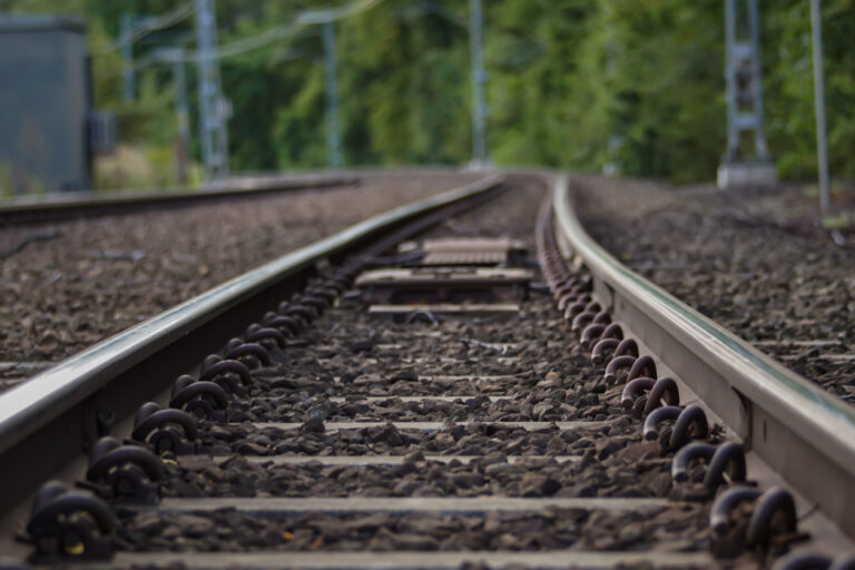A close up of railroad track during summer